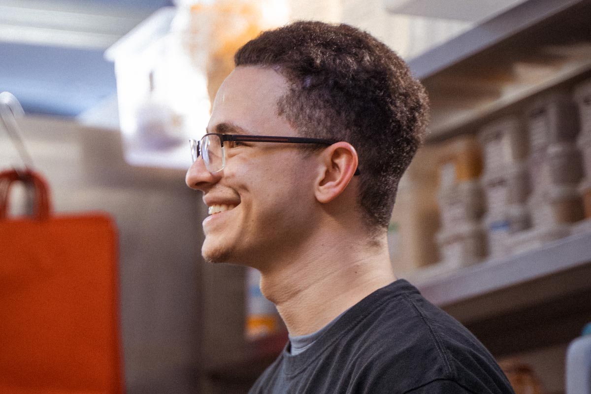 Cook smiling in a delivery kitchen